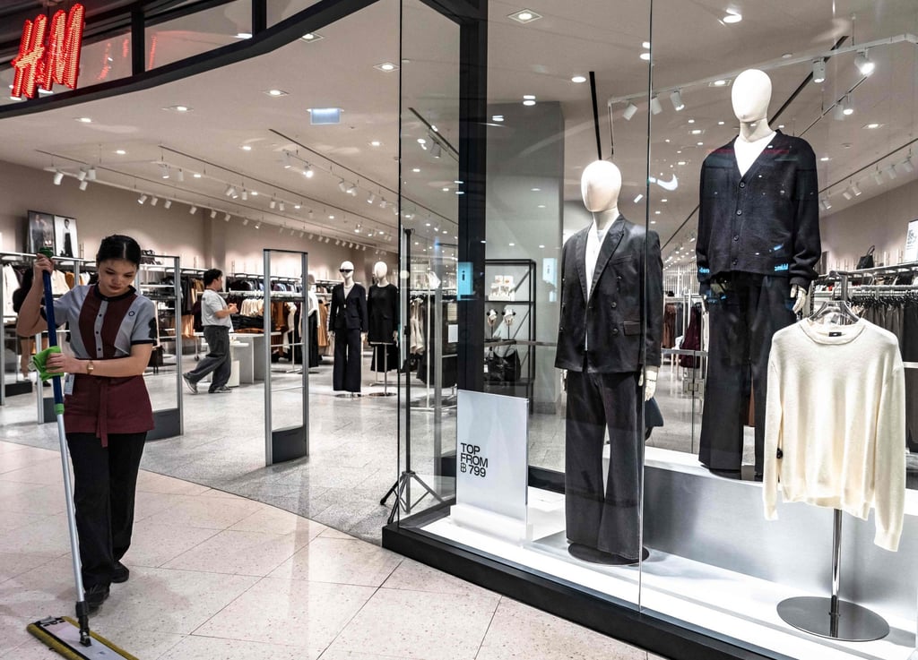 An employee mops the floor in front of a store selling black clothing at a shopping centre in Bangkok on Thursday. Photo: AFP An employee mops the floor in front of a store selling black clothing at a shopping centre in Bangkok on Thursday. Photo: AFP