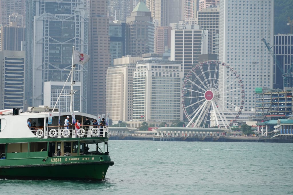 Li Ching takes the torch across Victoria Harbour on the Star Ferry. Photo: Felix Wong Li Ching takes the torch across Victoria Harbour on the Star Ferry. Photo: Felix Wong