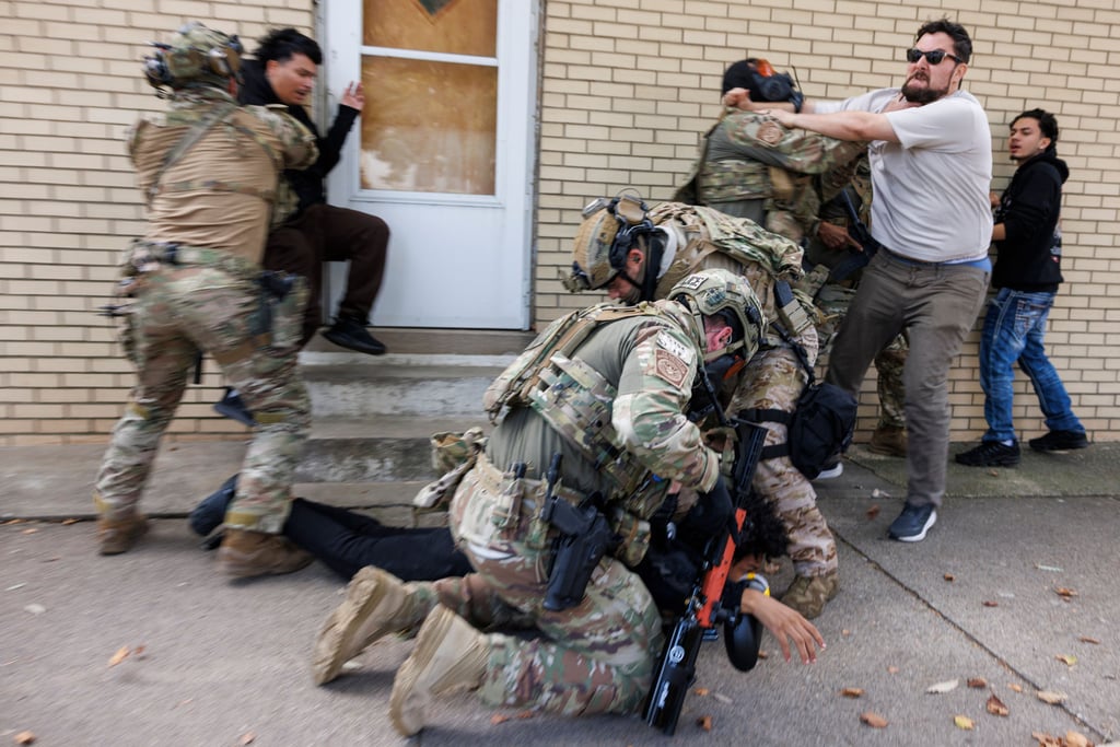 ICE agents detain a protester as other protesters try to stop them in East Side, Chicago. Photo: Chicago Sun-Times via AP ICE agents detain a protester as other protesters try to stop them in East Side, Chicago. Photo: Chicago Sun-Times via AP