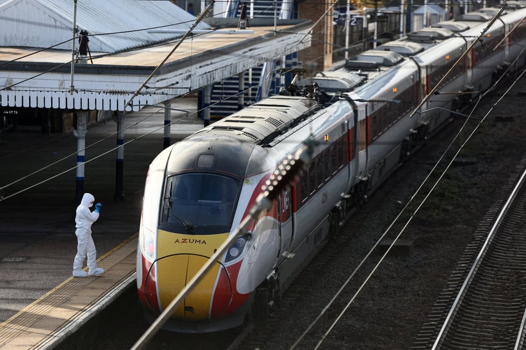 A forensic officer inspects the train at Huntingdon Station. Photo: Reuters A forensic officer inspects the train at Huntingdon Station. Photo: Reuters
