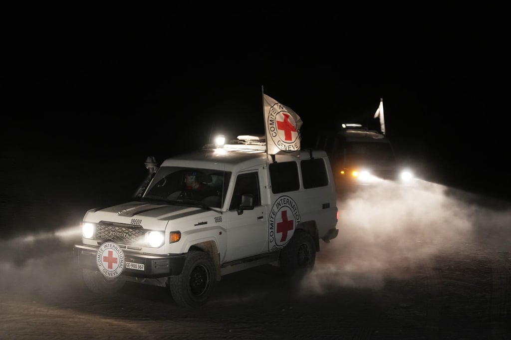 Red Cross vehicles carrying the bodies of three people believed to be deceased hostages. Photo: AP Red Cross vehicles carrying the bodies of three people believed to be deceased hostages. Photo: AP