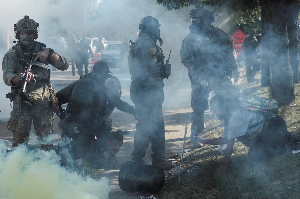 Tear gas rises during a stand-off with US Immigration and Customs Enforcement (ICE) and federal officers in the Little Village neighbourhood of Chicago, Illinois on October 4. Photo: Reuters Tear gas rises during a stand-off with US Immigration and Customs Enforcement (ICE) and federal officers in the Little Village neighbourhood of Chicago, Illinois on October 4. Photo: Reuters