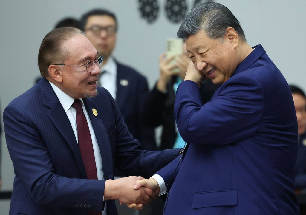 Malaysia’s Prime Minister Anwar Ibrahim (left) speaks with China’s President Xi Jinping at the Apec Leaders’ Meeting in Gyeongju on Friday. Photo: Yonhap/AFP
