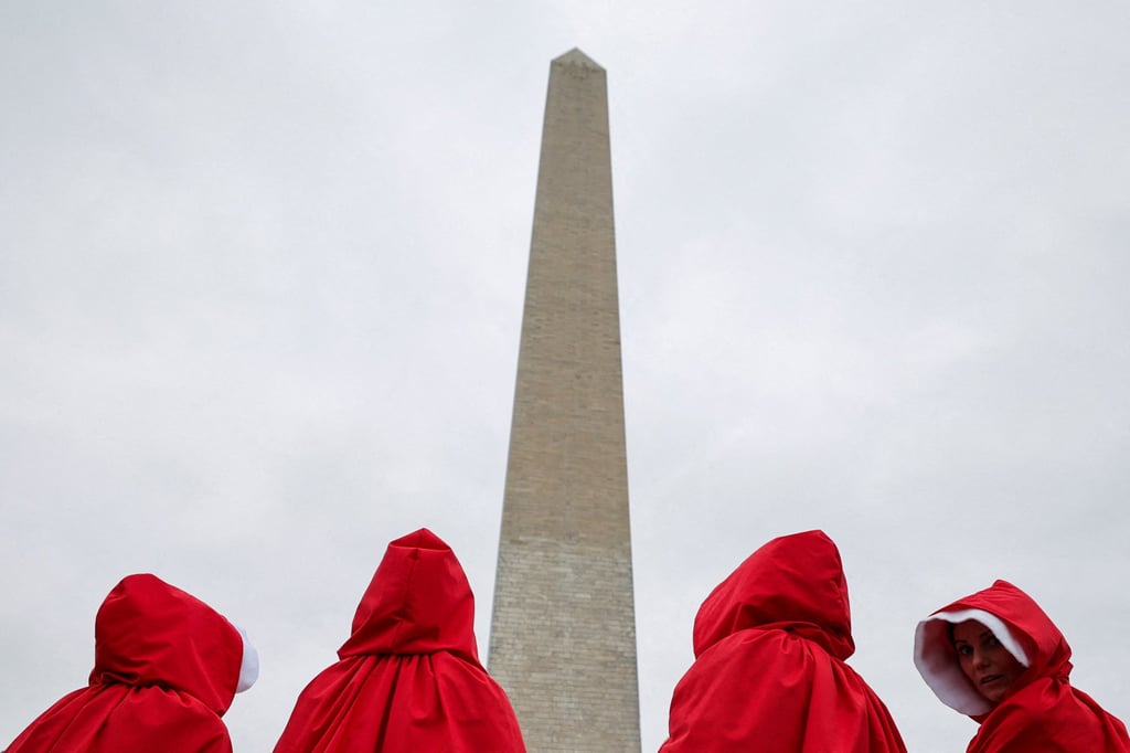 Demonstrators dressed as handmaidens from The Handmaid’s Tale take part in a protest against President Donald Trump and his adviser Elon Musk at the Washington Monument in April. Photo: Reuters.