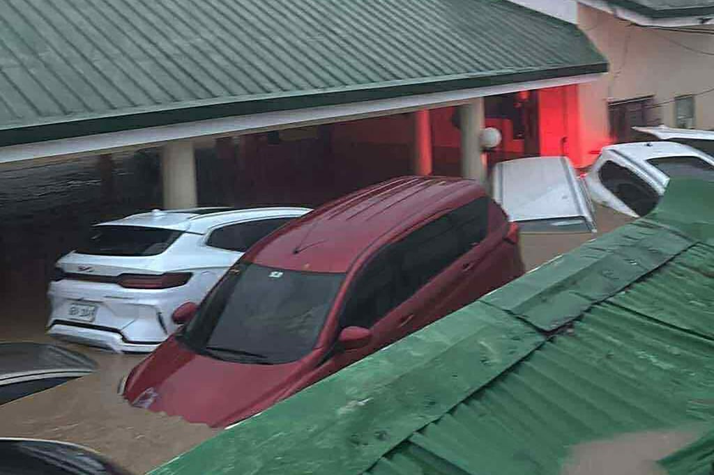 Cars submerged in floodwaters at a village in Cebu City. Photo: Don del Rosario/AFP Cars submerged in floodwaters at a village in Cebu City. Photo: Don del Rosario/AFP