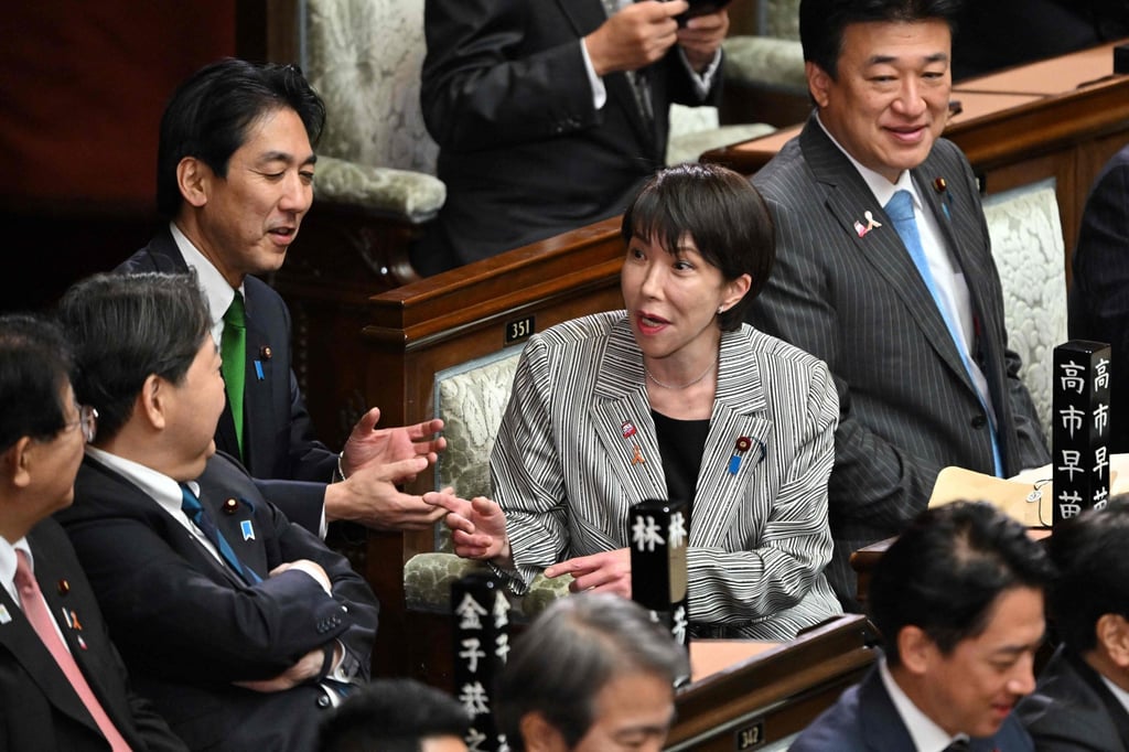 Japan’s Prime Minister Sanae Takaichi (centre) chats with her cabinet members before a session of parliament in Tokyo on Tuesday. Photo: AFP Japan’s Prime Minister Sanae Takaichi (centre) chats with her cabinet members before a session of parliament in Tokyo on Tuesday. Photo: AFP