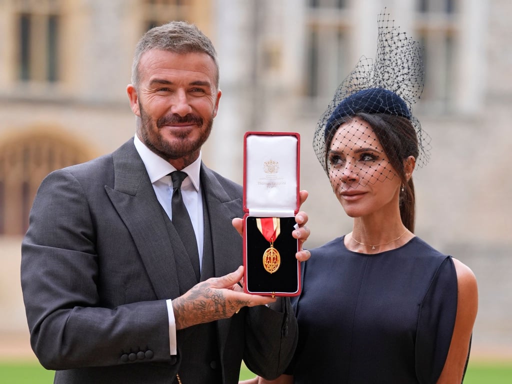 David Beckham and his wife, Victoria, pose for photographs after an investiture ceremony at Windsor Castle. Photo: AP