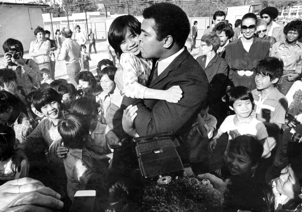 Heavyweight champion Muhammad Ali visits Kai Tak East Refugee Transit Centre in 1979. Photo: SCMP Archives