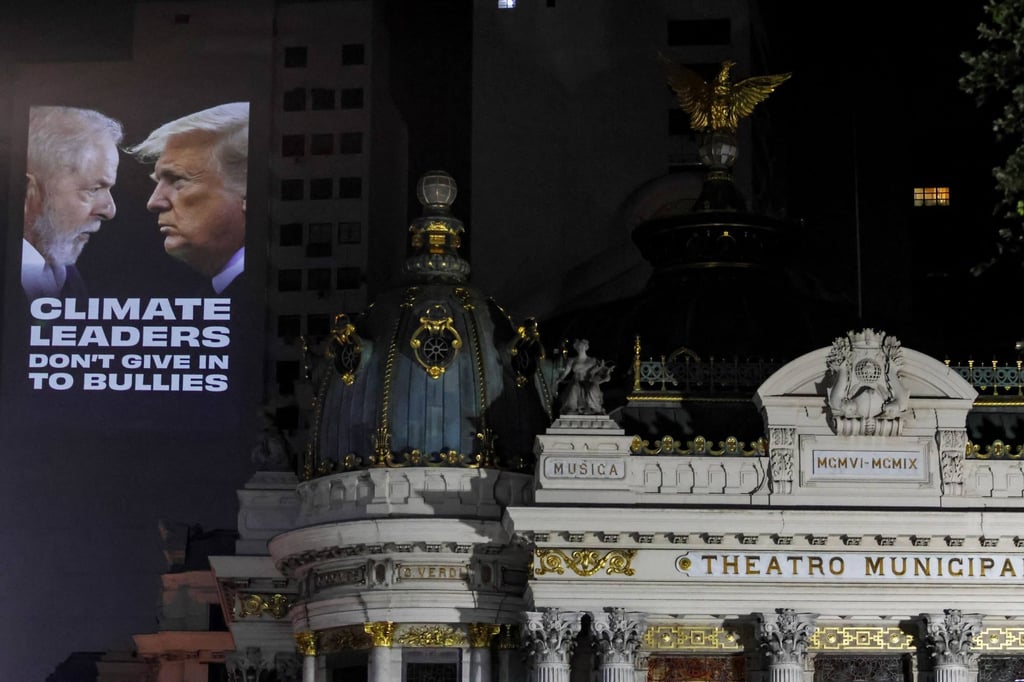 Environmental activists in Rio de Janeiro project images of Brazil’s President Luiz Inacio Lula da Silva and US President Donald Trump, demanding action on climate change. Photo: AFP