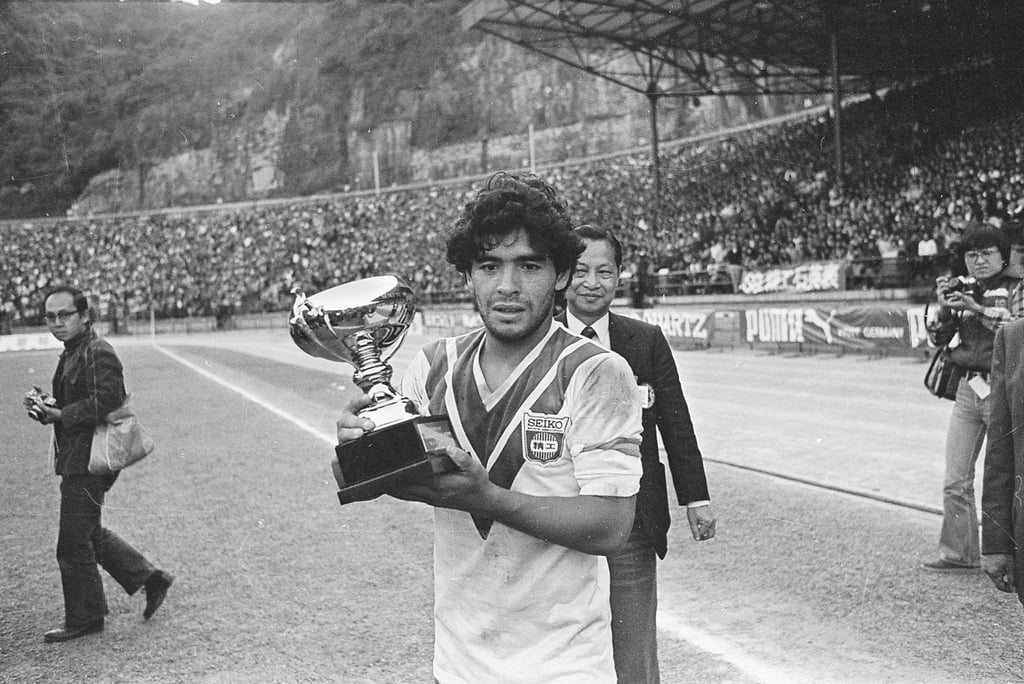Maradona, clad in the jersey of the Hong Kong-based Seiko soccer team, holds a trophy after his team Boca Juniors beat Seiko 2-0 at the Hong Kong Stadium, in 1982. Photo: SCMP Archives
