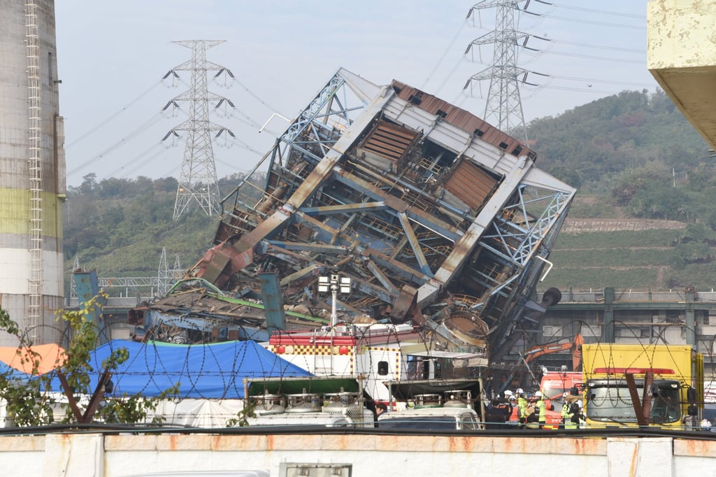 A rescue team work near a 60-metre tower which collapsed during demolition work at a decommissioned thermal power plant in Ulsan, South Korea on Friday. Photo: AP A rescue team work near a 60-metre tower which collapsed during demolition work at a decommissioned thermal power plant in Ulsan, South Korea on Friday. Photo: AP