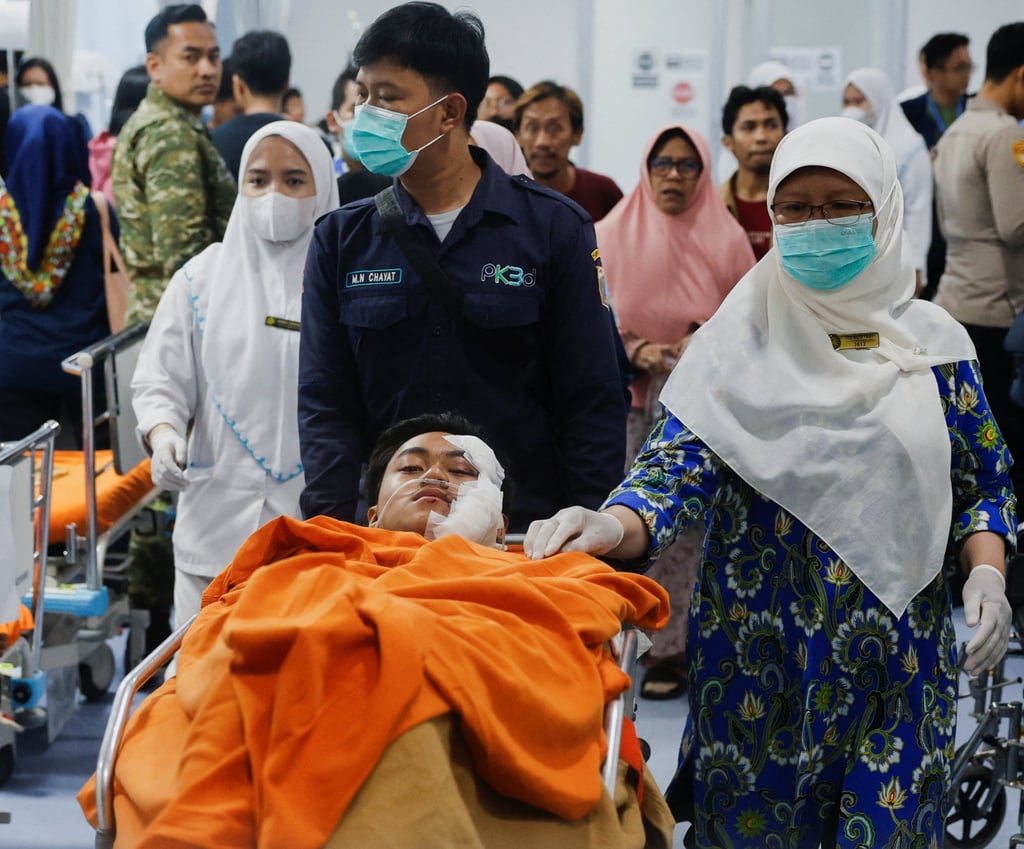 Medical workers push a student injured in Friday’s blast on a stretcher at the Jakarta Islamic Hospital. Photo: Reuters