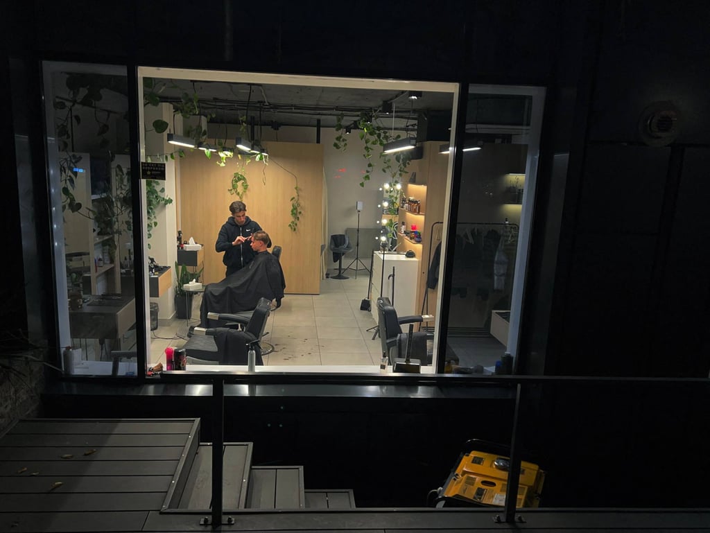 A barber works in his shop in Kyiv, powered by a generator, during blackout hours in Kyiv earlier this month. Photo: AFP A barber works in his shop in Kyiv, powered by a generator, during blackout hours in Kyiv earlier this month. Photo: AFP