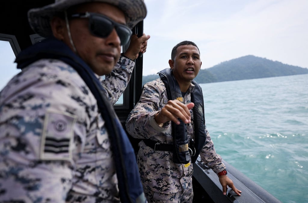 Malaysian Maritime Enforcement Agency officers search for victims during a search and rescue operation after a boat carrying members of Myanmar’s persecuted Rohingya community sank in waters near the Thailand-Malaysia border off Langkawi on Monday. Photo: Reuters