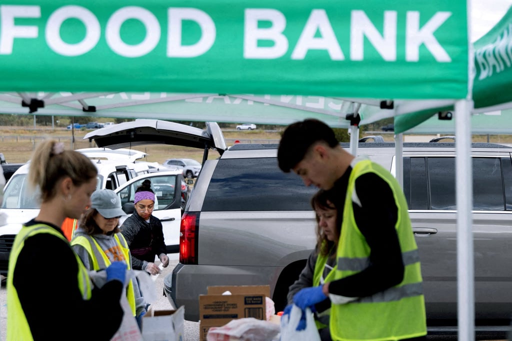 Volunteers place food items in vehicles during a mobile food distribution in Cedar Creek, Texas earlier this month. Photo: Reuters