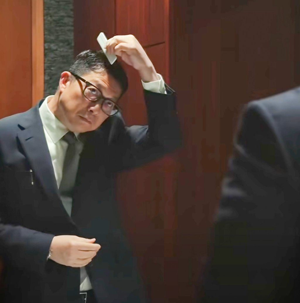 Secretary for Security Chris Tang carefully styles his hair. Photo: Handout