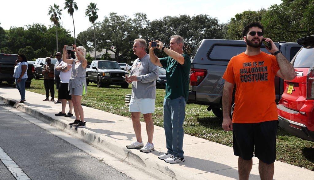 Coral Springs residents wait to enter their neighbourhood after the plane crash. Photo: South Florida Sun-Sentinel via AP Coral Springs residents wait to enter their neighbourhood after the plane crash. Photo: South Florida Sun-Sentinel via AP
