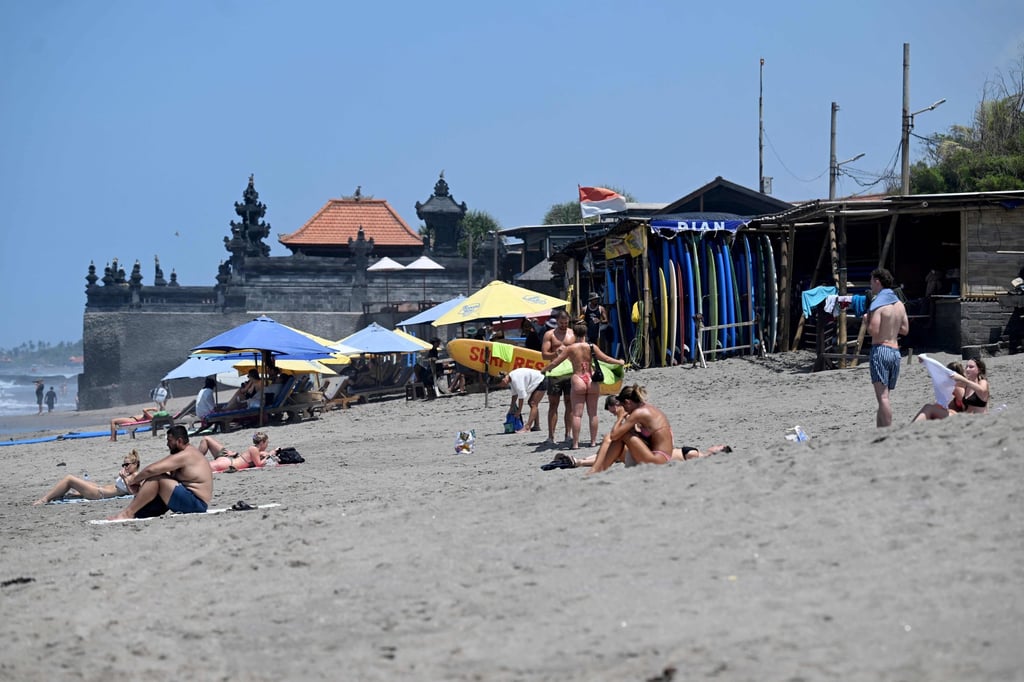 Foreign tourists enjoying a beach in Canggu on Bali. Local authorities have carried out regular passport spot checks at top tourism destinations such as Canggu, Ubud and Legian. Photo: AFP