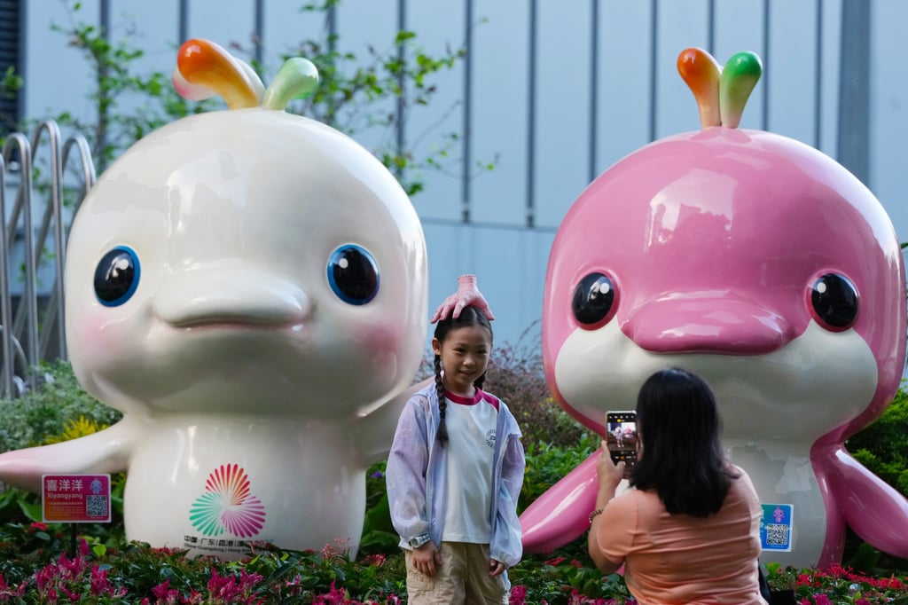 A girl with mascots Xiyangyang (left) and Lerongrong during the Halloween weekend. Photo: Jelly Tse A girl with mascots Xiyangyang (left) and Lerongrong during the Halloween weekend. Photo: Jelly Tse