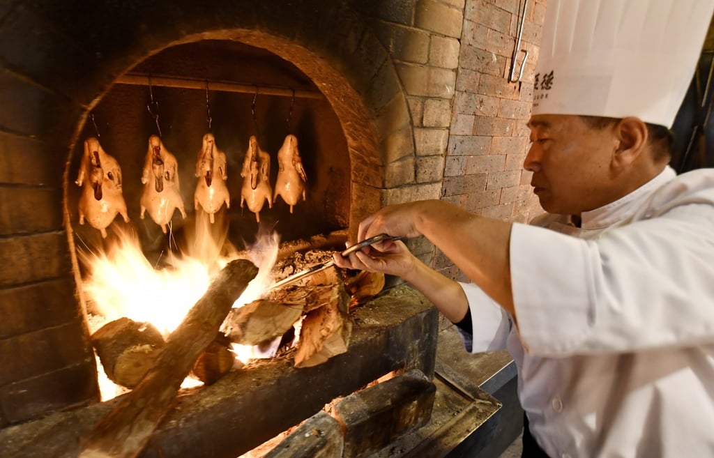 Chef Wu Yubo roasts ducks at Quanjude Roast Duck Restaurant in Beijing. Photo: Xinhua