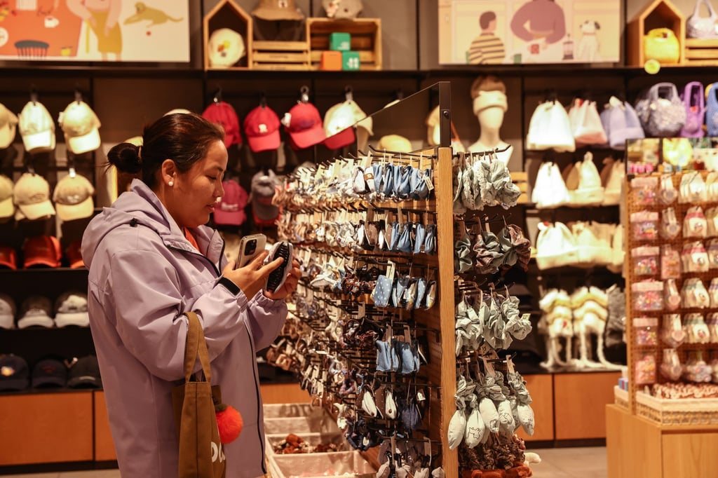 A woman shops at a clothing store in Beijing. China’s retail sales rose 2.9 per cent, decelerating for the fifth straight month in October. Photo: EPA