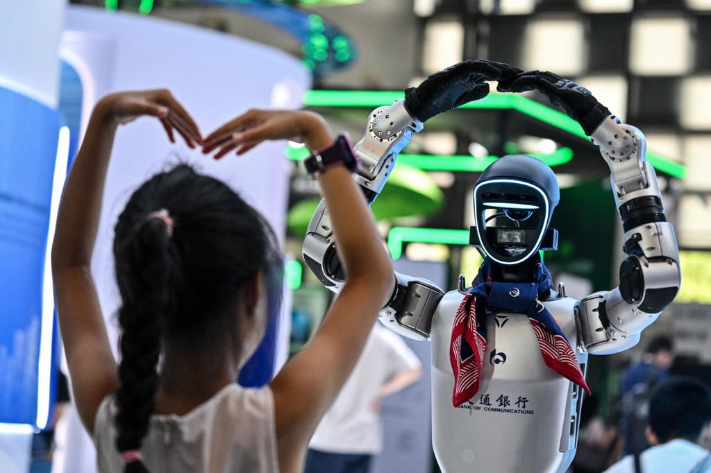 A girl plays with a robot during the World Artificial Intelligence Conference at the Shanghai World Expo and Convention Center in Shanghai, in July. Photo: AFP