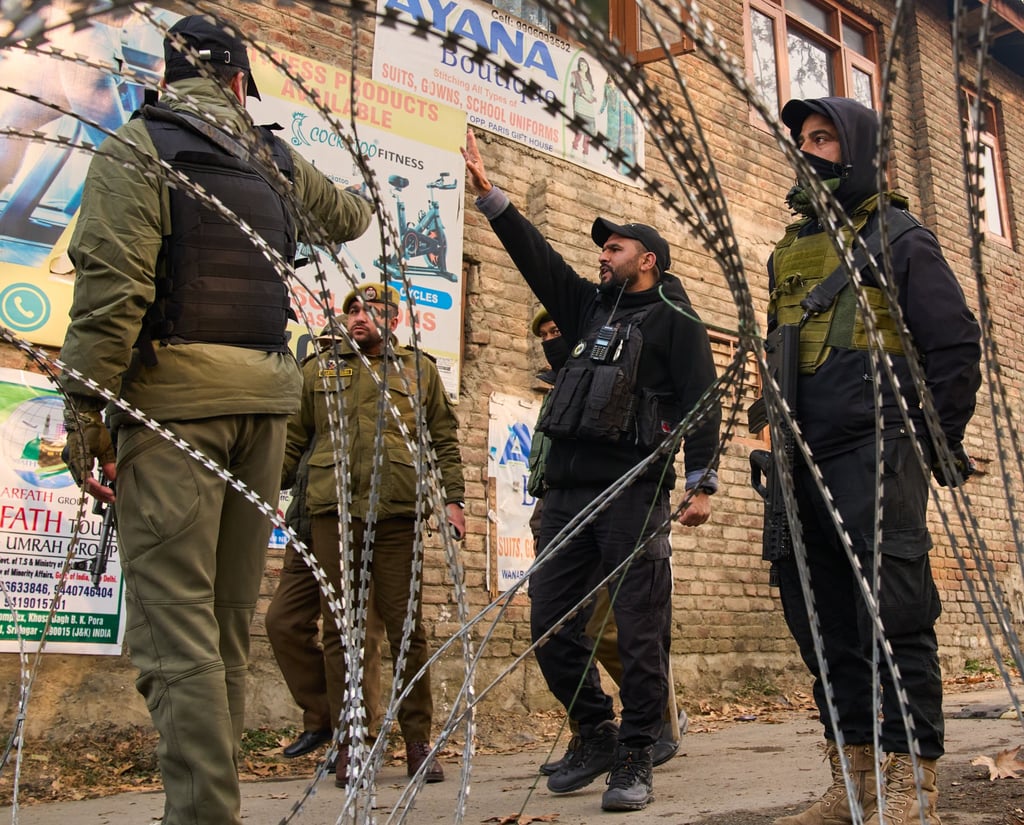 Indian security forces stand guard at a temporary checkpoint near the site of the explosion in India’s Kashmir on Saturday. Photo: AP