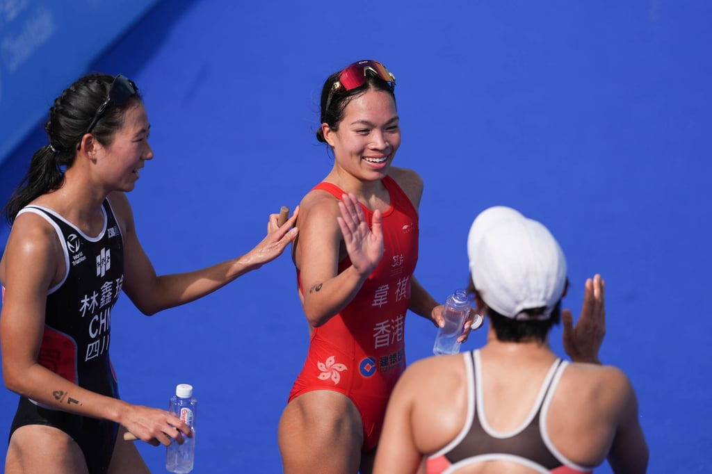 Hong Kong’s Cade Wright (centre, in red) celebrates finishing fourth. Photo: Eugene Lee