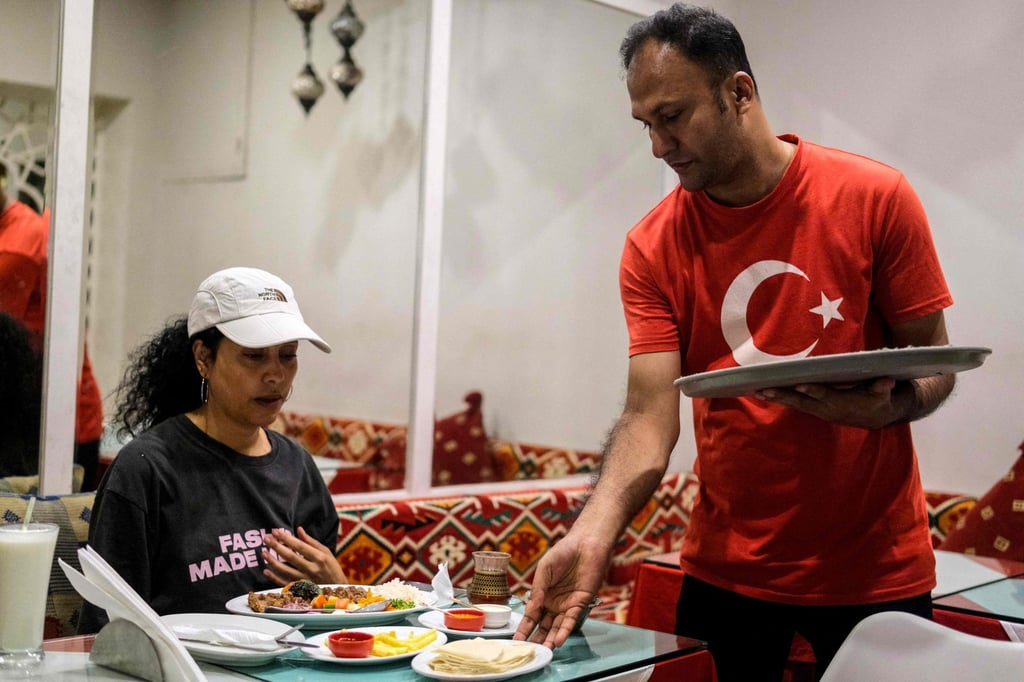 A waiter serves food to a customer at a Turkish restaurant in Dhaka on October 31. More Turkish restaurants are opening in Bangladesh and there is a general interest in learning the language. Photo: AFP A waiter serves food to a customer at a Turkish restaurant in Dhaka on October 31. More Turkish restaurants are opening in Bangladesh and there is a general interest in learning the language. Photo: AFP