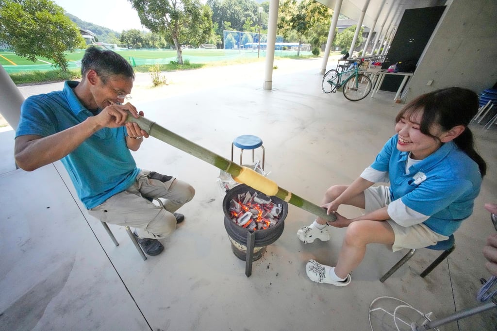 Staff make Baumkuchen, a German layered cake, during a workshop of Juchheim Ninoshima Welcome Centre and Outdoor Activity Camp at Ninoshima island in Hiroshima, western Japan. Photo: AP Staff make Baumkuchen, a German layered cake, during a workshop of Juchheim Ninoshima Welcome Centre and Outdoor Activity Camp at Ninoshima island in Hiroshima, western Japan. Photo: AP