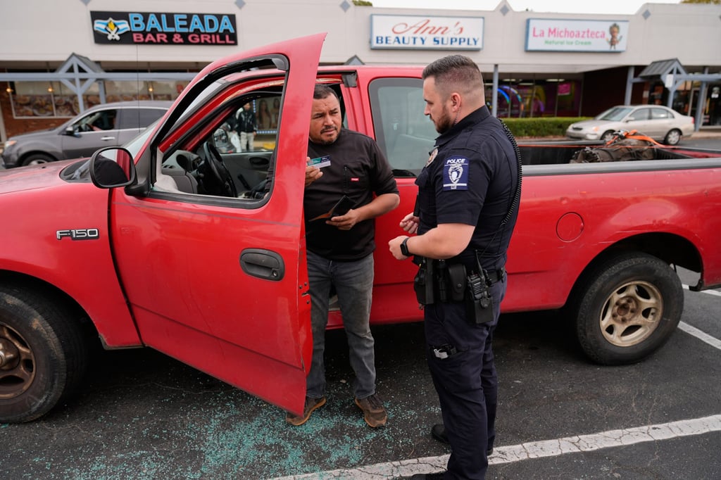 Willy Aceituno makes a police report after US Customs and Border Protection officers broke his truck’s window in Charlotte on Saturday. Photo: AP Willy Aceituno makes a police report after US Customs and Border Protection officers broke his truck’s window in Charlotte on Saturday. Photo: AP