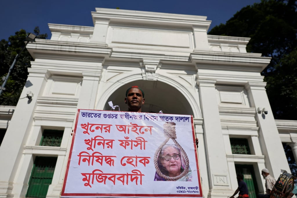 A man holds a poster in front of the court demanding capital punishment for ousted prime minister Sheikh Hasina ahead of the verdict on charges of crimes against humanity for a deadly crackdown on student-led protests in 2024. Photo: Reuters