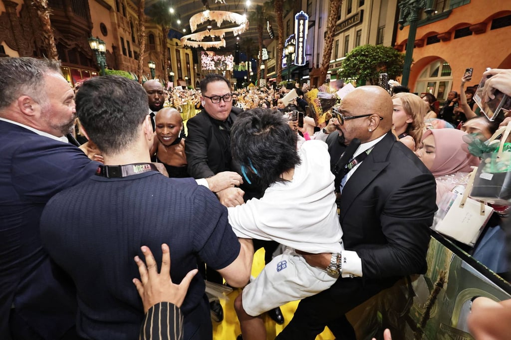 Johnson Wen is restrained by security guards at the premiere of “Wicked: For Good” in Singapore last week. Wen was jailed for nine days for attacking pop star Ariana Grande at the event. Photo: The Straits Times / AFP