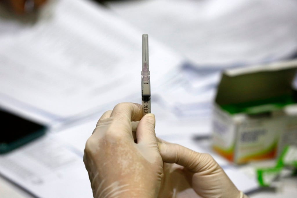 A healthcare worker prepares a vaccine dose during an immunisation programme for schoolchildren in Banda Aceh, Indonesia, on November 6. Photo: EPA