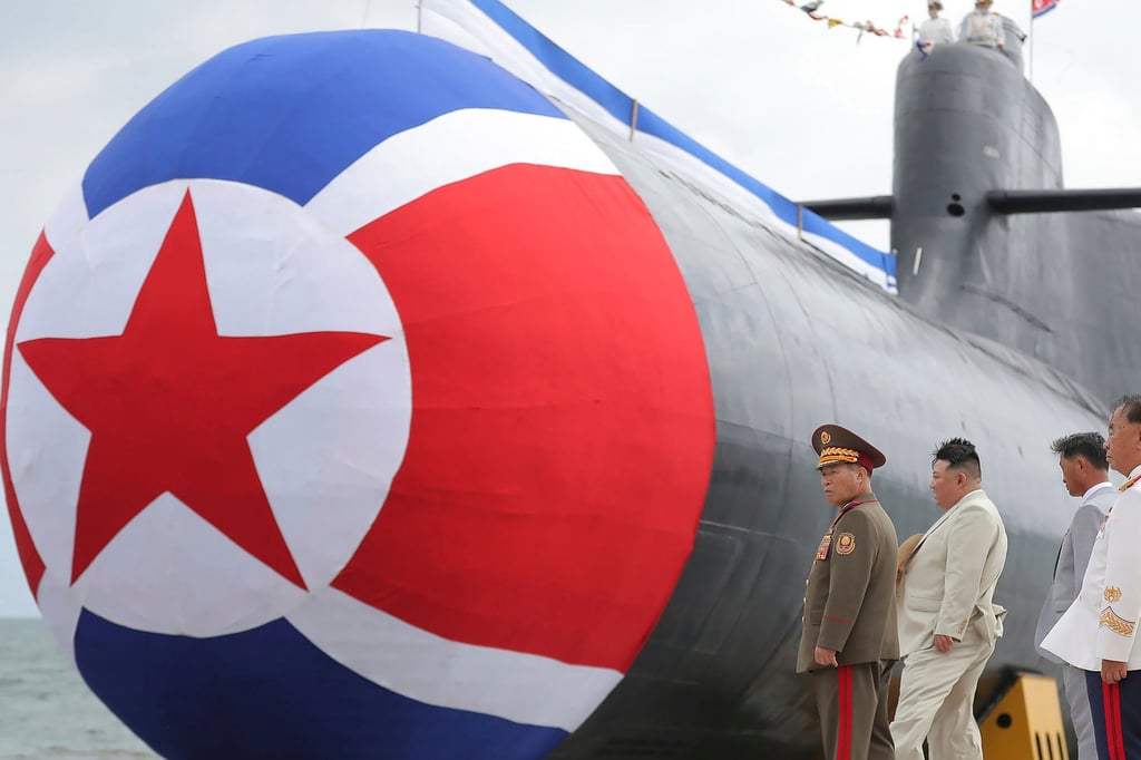 North Korean leader Kim Jong-un (second from left) inspects what state media described as a new nuclear attack submarine in 2023. Photo: KCNA/KNS/AP