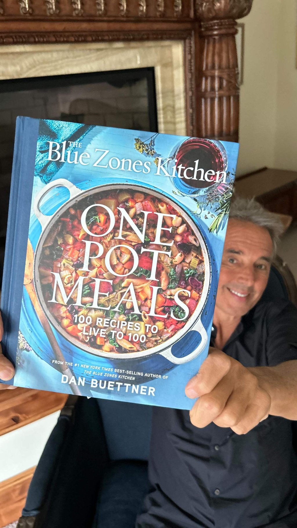 Buettner holds a copy of his new book. Photo: Instagram/danbuettner