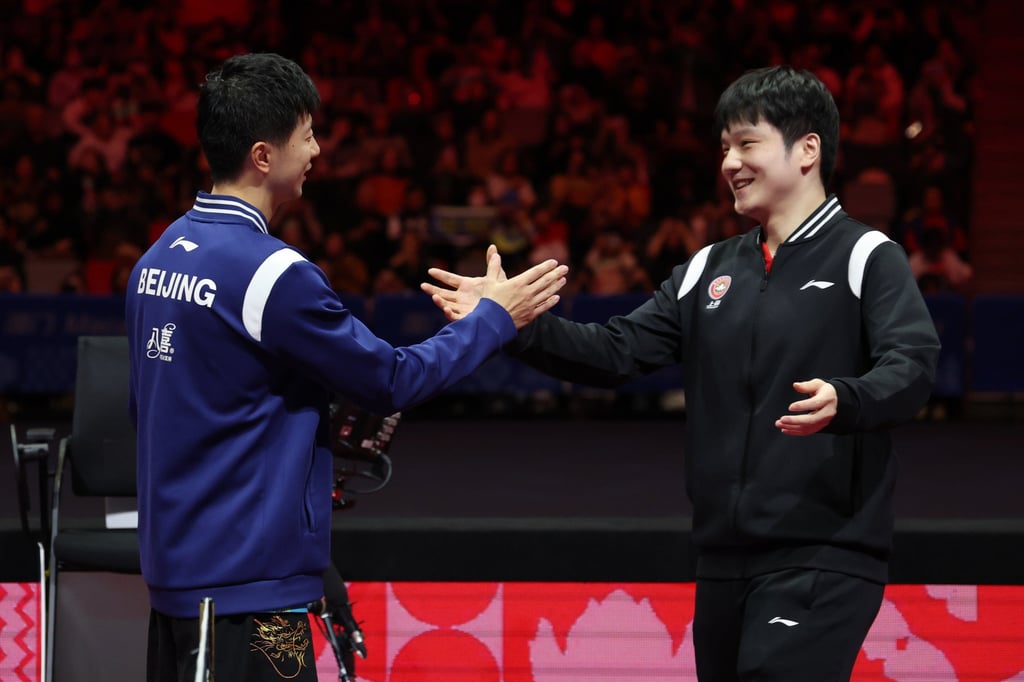 Fan Zhendong (right) and Ma Long greet each other after the final. Photo: Xinhua Fan Zhendong (right) and Ma Long greet each other after the final. Photo: Xinhua