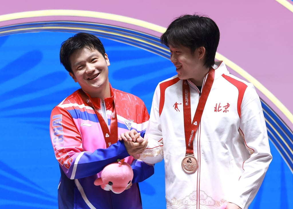 Singles champion Fan Zhendong (left) with bronze medallist Wang Chuqin on Sunday. Photo: Xinhua