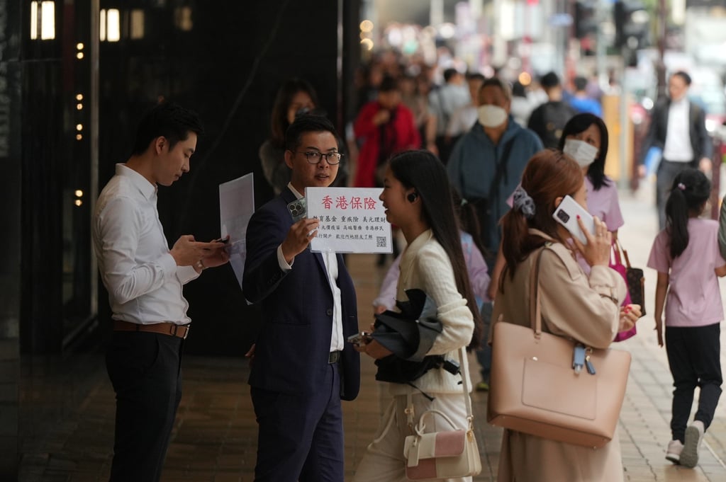 Insurance sales agents approach mainland tourists on Canton Road, Tsim Sha Tsui. Photo: Eugene Lee