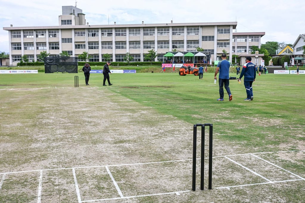 Umpires and coaches check the wicket before the start of a game between Hong Kong and Japan in Sano. Photo: AFP Umpires and coaches check the wicket before the start of a game between Hong Kong and Japan in Sano. Photo: AFP