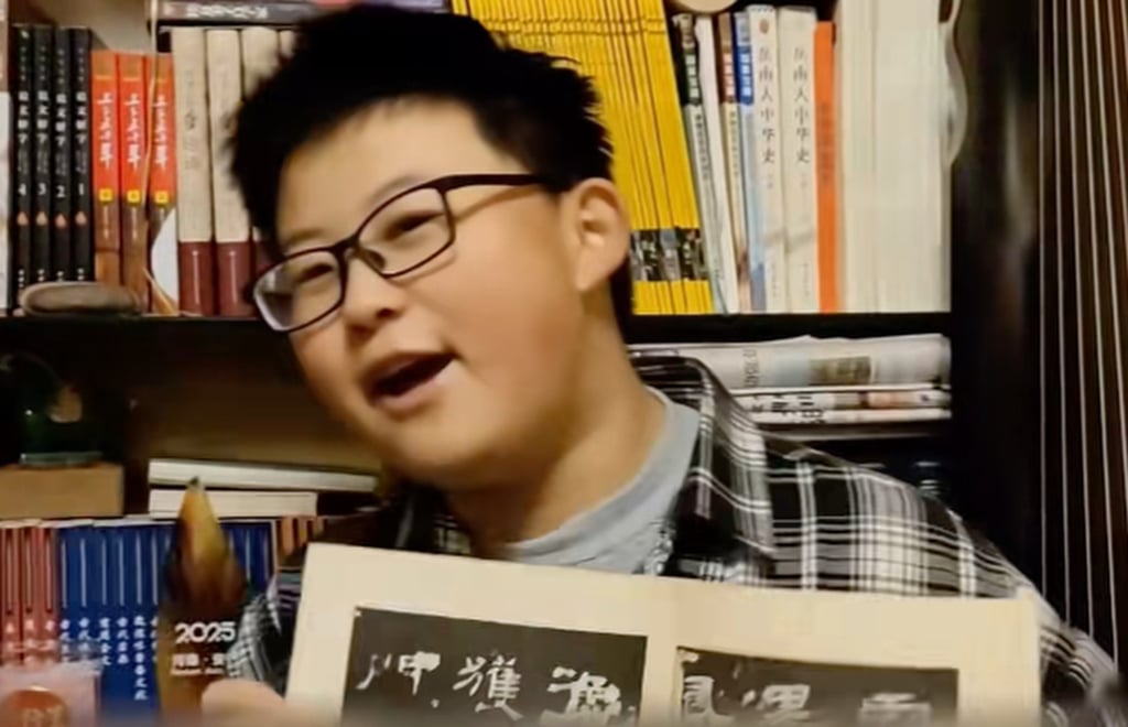 Xie Zhaoyutong shows off a favourite book in his artefact-packed bedroom. Photo: Douyin Xie Zhaoyutong shows off a favourite book in his artefact-packed bedroom. Photo: Douyin