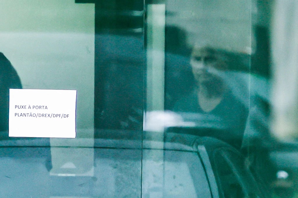 Jair Bolsonaro is seen through the door of the Federal Police headquarters, where he is imprisoned, in Brasilia on Sunday. Photo: AFP
