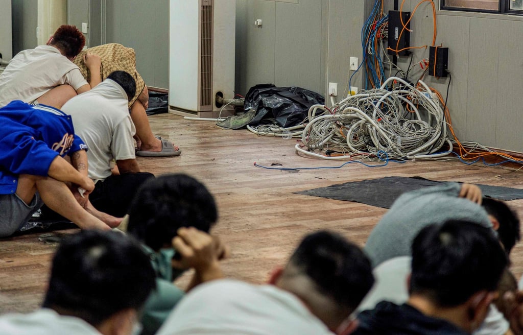 Alleged scam centre workers and victims sit next to dismantled IT and electronic appliances during a crackdown in Shwe Kokko on February 18. Photo: AFP Alleged scam centre workers and victims sit next to dismantled IT and electronic appliances during a crackdown in Shwe Kokko on February 18. Photo: AFP
