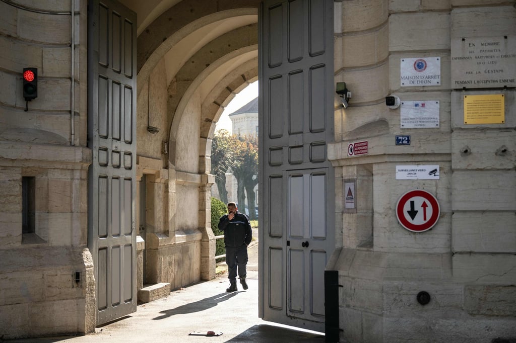 A member of the prison staff behind the entrance door of the jail in Dijon on Thursday. Photo: AFP