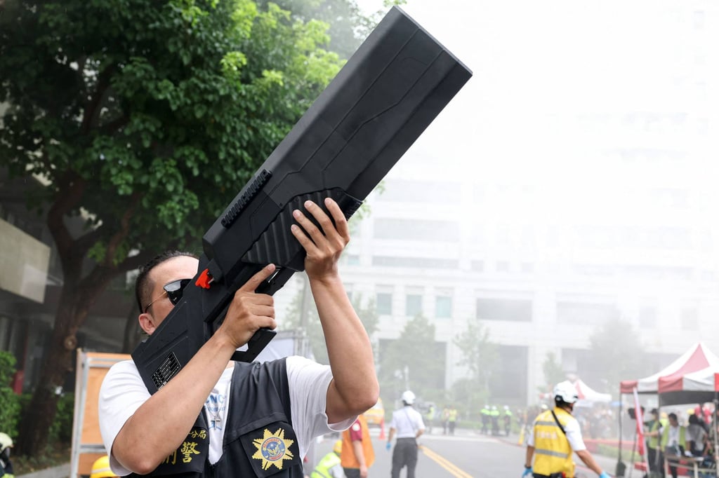 A participant uses an anti-drone weapon during a civilian evacuation drill held in Taipei in July. Photo: AFP