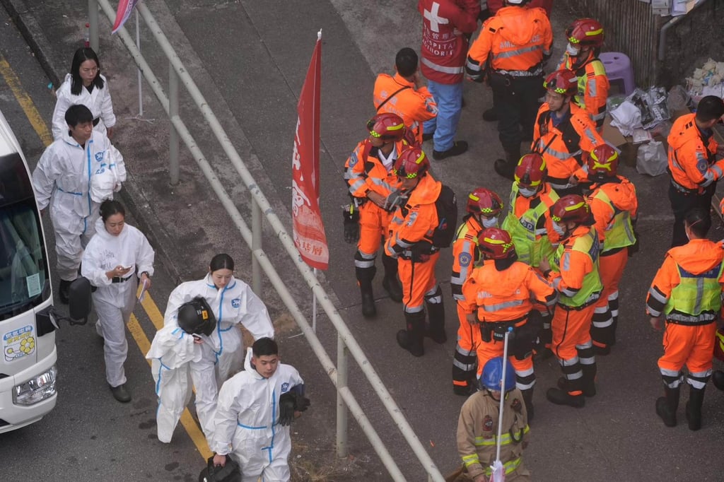 Members of the Disaster Victim Identification Unit (DVIU) enter the zone in protective clothing. Photo: Elson Li