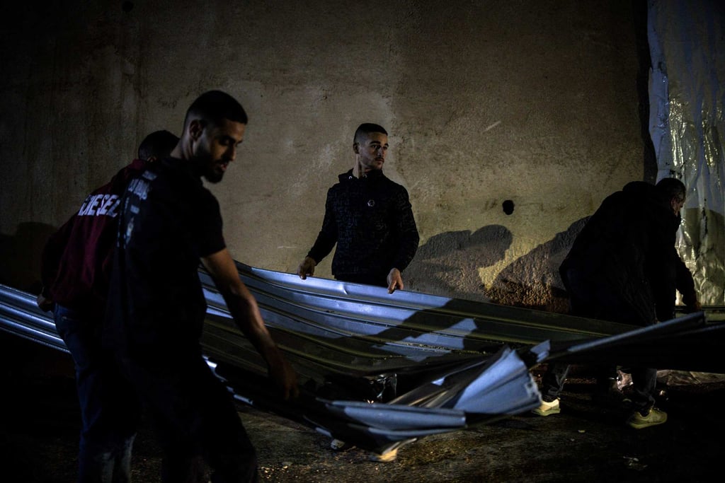People help clean up at the site of a reported shooting that left two Palestinians dead during an Israeli military operation in the occupied West Bank city of Jenin on Thursday. Photo: AFP People help clean up at the site of a reported shooting that left two Palestinians dead during an Israeli military operation in the occupied West Bank city of Jenin on Thursday. Photo: AFP