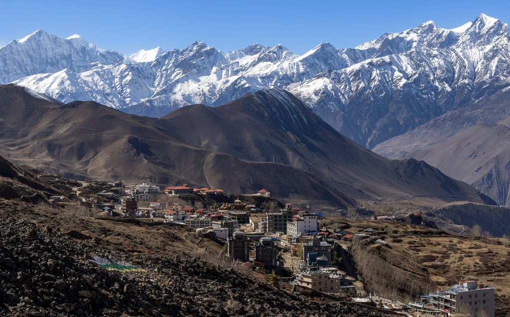 Snow-covered mountains tower over a village in Nepal’s Mustang district on November 12. Photo: EPA