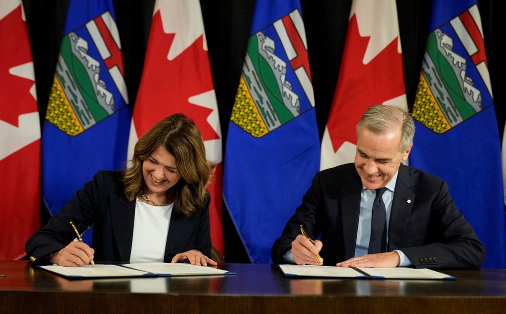 Canada’s Prime Minister Mark Carney and Alberta’s Premier Danielle Smith sign a Memorandum of Understanding in Calgary, Alberta, on Thursday. Photo: Reuters Canada’s Prime Minister Mark Carney and Alberta’s Premier Danielle Smith sign a Memorandum of Understanding in Calgary, Alberta, on Thursday. Photo: Reuters