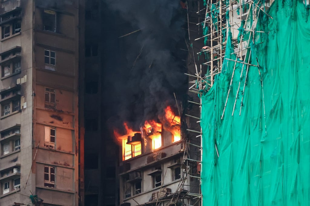 Flames and smoke billow from the windows of a flat in Wang Fuk Court. Photo: Dickson Lee Flames and smoke billow from the windows of a flat in Wang Fuk Court. Photo: Dickson Lee